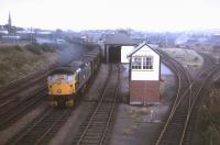 The daily Far North freight from wick and Thurso to Inverness powers through Invergordon in the summer of 1973. The Invergordon Harbour branch (for coal traffic) trails off to the right. The photographer (a temporary BR employee during student holidays) had no head for heights, but managed to steel himself to climb a signal gantry to get the best possible view.<br><br>[David Spaven //1973]