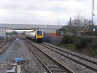 A northbound CrossCountry DMU entering Ashchurch station on 29 December 2011. The MoD exchange sidings stand in the left background.<br><br>[Peter Todd 29/12/2011]