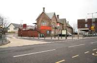 Lanark railway station, looking north east across Bannatyne Street on Boxing Day 2011. The two platform terminus is reached via a short branch off the WCML and is at the southern end of the Argyle Line. The stately old (1854/5) building continues to more than hold its own in a surrounding sea of modernity including the local medical centre (left) and the stilt-supported Department of Work and Pensions (right). The station replaced the original 1848 Lanark station on the WCML which was renamed Cleghorn [see image 15178].<br><br>[John Furnevel 26/12/2011]