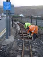 Track replacement being carried out on the Fairbourne Railway near Penrhyn South Drive level crossing on 7 December 2011. The work was being undertaken in advance of the first of the season's 'Santa Specials' due to run three days later. [See image 31267]<br><br>[David Pesterfield 07/12/2011]