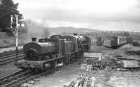 Shunting at 'The Boat' in 1986. Barclay 0-4-0ST <i>Clyde</i> shunts an NBL 0-4-0 DH and Black 5 no. 5025 at Boat of Garten in this view from the south signal cabin on 27 April 1986. To the right of the Black 5 are the remains of Ivatt Class 2 2-6-0 no. 46428 [see image 19072].<br><br>[John McIntyre 27/04/1986]
