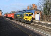 Freightliner 66535 passing eastbound through Cholsey Station on 5 January with a container train.<br><br>[Peter Todd 05/01/2012]