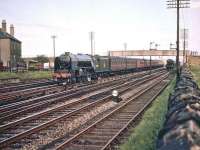 A2 Pacific no 60507 <I>'Highland Chieftain'</I> runs through Saughton Junction on 11 August 1957 and is about to turn north on the route towards the Forth Bridge. The train has just passed a freight standing at signals on the right beyond the footbridge.<br><br>[A Snapper (Courtesy Bruce McCartney) 11/08/1957]