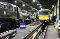 Evening shed scene at Haworth. With services finished for the day most locomotives are back under cover. This view shows BR 4MT 80002, L&YR 0-6-0 957, LMS 2MT 41241 and Railbus M79964 with many other locos also present in the shed. The space in the foreground should have housed Class 25 25059 but this had just been turned out to recover a failed diesel shunter from Ingrow West. Picture taken with kind permission of KWVR staff.  <br><br>[Mark Bartlett 07/01/2012]