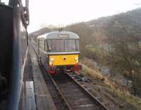 Morning services crossing at Damens loop in the Worth Valley. The railbus is returning to Oxenhope after two shoppers' trips to Keighley and is waiting for the first steam train of the day to clear the southern section of the branch. Midland 4Fs were not huge engines but 43924 dwarfed the little railbus, seen here from the footplate as single line tokens were exchanged.<br><br>[Mark Bartlett 07/01/2012]