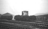 Locomotive servicing facilities at Fairlie Pier in use on Monday 25 February 1963. In the background, beyond the fence running along the north side of the station, are the buildings and equipment associated with the NATO boom defence base. The former locomotive shed (in use by a boatbuilder at that time) is off picture to the left. [See image 37141].<br><br>[R Sillitto/A Renfrew Collection (Courtesy Bruce McCartney) 25/02/1963]