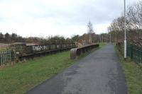 Padiham station closed to regular passengers services in 1957 but summer excursion trains continued to call here until 1964. The two platforms were situated just beyond the bridge but were swept away many years ago. The goods yard, now awaiting redevelopment, was in the area to the left of the station. The rails from Rose Grove to Padiham Power Station were only lifted recently to create the cycle path shown here in this view looking west towards Great Harwood. <br><br>[Mark Bartlett 07/01/2012]