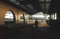 Looking out from the station concourse at Inverness in September 1975. The 08.20 train to Edinburgh, headed by a Class 24 and 26, is poised to depart. With a near 4-hour journey time (via Stirling) this was for many years the fastest service on the Highland Main Line.<br><br>[Frank Spaven Collection (Courtesy David Spaven) /09/1975]