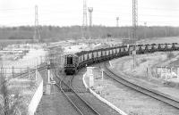 Having just propelled its train of coal out of Monktonhall Colliery, 08411 draws forward from the former Bilston Glen branch towards Millerhill Yard on 27 February 1995. In the backround is the disused ECML Electrification Yard which utilised the Waverley Route sidings.<br><br>[Bill Roberton 27/02/1995]