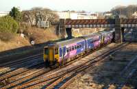 A Class 156/142 double act heads west from the station stop at Kirkham and Wesham en-route to Blackpool North on 14 January 2012. The train is about to cross Kirkham North Jct where the line to Blackpool South diverges and, once upon a time, the direct line to Blackpool Central.<br><br>[John McIntyre 14/01/2012]