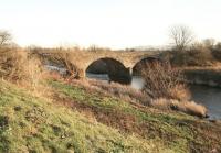 Alongside the River Almond at Kirkliston under a low winter sun in January 2012. View south east, with the village off picture to the left and the Pentland Hills in the right background to the south of Edinburgh. The bridge carried the branch from Ratho (Lower) to Dalmeny and is now a walkway. The line closed to passengers in 1930 (Kirkliston being the only intermediate station) but continued to handle goods traffic, including a distillery at Kirkliston and a Navy victualling depot at the north end [see image 36169] for many years, before closing completely in 1966.   <br><br>[John Furnevel 13/01/2012]