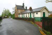 Standing in the rain at the exit from the eastbound platform (running behind the fence on the left) at Bardon Mill station on Sunday morning 7 May 2006. Ahead lies Station Road with the former station buildings and station master's house.<br><br>[John Furnevel 07/05/2006]