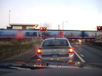 The late running 15.50 ex Middlesbrough TransPennine Express service to Manchester Airport rushes past Low Gates signalbox on 14 January as it approaches Northallerton Station. <br><br>[David Pesterfield 14/01/2012]