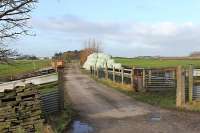 One of the few discernible stretches of trackbed on the old Knott End line is at Nateby but it has been turned into a farm access road as seen here. This view taken from the level crossing looks west towards Pilling with the old station area immediately behind the camera. [See image 22572]<br><br>[Mark Bartlett 21/01/2012]