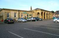 Looking west from the Langborne Road entrance across the car park at Whitby on 2 October 2008. The station (Whitby's second), dates from 1847 and the name has alternated several times between Whitby Town and plain Whitby. The arched portico over the main entrance carries the logo of the North Yorkshire Moors Railway, whose staff now handle ticket sales for Northern Rail Esk Valley Line services to Middlesbrough as well as their own trains to Pickering.<br><br>[John Furnevel 02/10/2008]