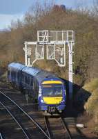 170 470 heads for Haymarket out of Dalmeny up loop where it had reversed after arriving as the 12.44 class 5 (empty stock) working from Linlithgow, on 22 January 2012. The top of the Forth Bridge can be seen above the trees.<br><br>[Bill Roberton 22/01/2012]