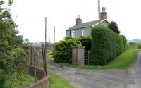 The old station entrance at Maxton on the Kelso branch between St Boswells and Roxburgh, photographed in June 2005. View is south east away from the village, with the site of the level crossing on the brow of the hill.<br><br>[John Furnevel 01/06/2005]