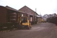 Kegs of Tennents beer are fork-lifted out of air-braked wagons (with palletised can traffic in the background) in this typical scene at Inverness Freight Depot in the mid-1970s. The beer originated from Wellpark Brewery, just a few hundred yards from Glasgow's High Street Freight Depot, and travelled to Inverness by overnight freight train for local road distribution.<br><br>[Frank Spaven Collection (Courtesy David Spaven) //]