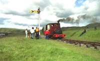 The driver of Hunslet 0-4-0ST no 823 <I>'Irish Mail'</I> has a rest as his fireman takes a few pictures while the train waits at the halt on the Leadhills 2 ft gauge railway in July 1993.<br><br>[John McIntyre 11/07/1993]