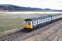 A westbound DMU seen near Mosstowie in April 1979 shortly after leaving Elgin.<br><br>[Peter Todd 02/04/1979]