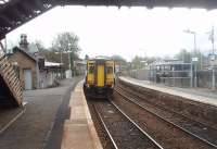 An East Kilbride bound service, formed by 156512, calls at Busby and will then join the single line section that starts just beyond the platforms.<br><br>[Mark Bartlett 14/04/2011]