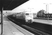 47581 <I>Great Eastern</I> takes a train of oil tanks west through Southall station on 18 November 1980.<br><br>[John Furnevel 18/11/1980]