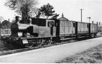 Whittingham Hospital Railway CMHW No.2, a Barclay 0-4-2T, stands at Grimsargh with its train of converted LNWR brakevans. This image has the air of a posed photograph as these <I>coaches</I> would normally be in the CMHW platform road in the foreground rather than on the run round loop as seen. It may have been taken at the time when the vehicles replaced the worn out ex NLR and L&YR coaches on this free to ride service. The home signal in the background is on the Longridge <I>main line</I> where the other Grimsargh station, by this time closed, can be seen on the far right.<br><br>[David Hindle Collection //]