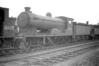 Another one of the many redundant steam locomotives to have spent time 'stored' in the yard at Bathgate pending disposal. This is 'Scott' class no 62432 <I>Quentin Durward</I>, photographed there in April 1959. The 4-4-0 had been withdrawn from Hawick shed in December 1958 and was eventually cut up at Motherwell Machinery & Scrap, Wishaw, in February 1960.<br><br>[Robin Barbour Collection (Courtesy Bruce McCartney) 21/04/1959]