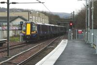 The 11.53 service to Glasgow Central departs from the recently extended platform 1 at Largs on 28 January 2012.<br><br>[Colin Miller 28/01/2012]