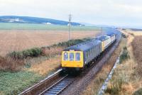 View east at Alves station on the Aberdeen - Inverness line on 12 December 1978. The station closed in May 1965 and the station building is now a private residence. The track has also been relaid through the centre of the formation since the photograph was taken [see image 6173].  <br><br>[Peter Todd 12/12/1978]