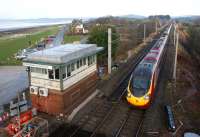 In January 2012 Hest Bank still retains a signalbox, although downgraded to a gate box or, as the name states, a level crossing frame. The fact that the box is to be closed under current Network Rail plans is perhaps reflected by the lack of maintenance on the structure (the west side, facing Morecambe Bay, is very much the worse for wear). With the South Lakeland Hills in the background, an up Pendolino rushes towards its next stop at Lancaster on 28 January 2012.<br><br>[John McIntyre 28/01/2012]