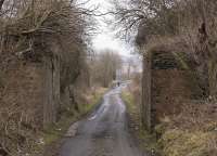 Abutments of the railway bridge over Colquhally Road which carried the Lochgelly Iron & Coal Company's line to the Nellie Colliery. The ironworks closed around 1895 while the pit lasted another seventy years.<br><br>[Bill Roberton 31/01/2012]