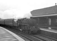 The north end of Kilwinning station on a grey and overcast Saturday 25 May 1963. A standard class 5 4-6-0 is running into the Largs platform with a train from Glasgow.<br><br>[R Sillitto/A Renfrew Collection (Courtesy Bruce McCartney) 25/05/1963]