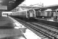 View from platform 13 at a wet Clapham Junction in September 1981 as class 423 (4-VEP) 7825 arrives on a Bognor Regis - London Victoria service.<br><br>[John Furnevel 18/09/1981]
