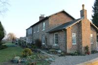 Although it closed to passengers at the end of 1930 Hovingham Spa station, on the Gilling to Malton line, survives in good condition as a private residence. Freight traffic continued until 1964. View towards Malton from the site of the old level crossing. <br><br>[Mark Bartlett 03/02/2012]