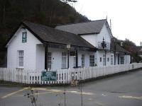 The former Penmaenpool Station station master's house, ticket office and waiting room, complete with hanging Platform 1 sign, on the south side of former Cambrian Railway route to Dolgellau, seen looking towards Morfa Mawddach in December 2011. It now forms an annexe to the George III Hotel beyond. <br><br>[David Pesterfield 07/12/2011]