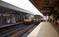 The old and the new share adjacent platforms at Cardiff Central in September 1991. On the left a two car Derby built unit waits to head east from the station whilst on the right a Class 155 Sprinter prepares to depart westwards.<br><br>[John McIntyre /09/1991]