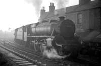 A freight waiting to leave the Ardrossan port area on a winter's day in December 1962 behind Black 5 no 45457. The train is held at signals on the south side of Princes Street level crossing. [See image 37014]<br><br>[R Sillitto/A Renfrew Collection (Courtesy Bruce McCartney) 29/12/1962]