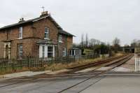 Barton Hill has been closed since 1930, like most other intermediate stations between York and Scarborough. It is still in use as a private house alongside the line, as seen in this view from the level crossing towards York.<br><br>[Mark Bartlett 02/02/2012]