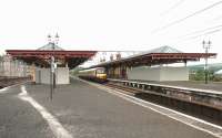 View west at Dumbarton Central in July 2005 with a Glasgow bound train standing at platform 1. The original platform 1, on the extreme right, is closed and the track lifted [see image 4659].<br><br>[John Furnevel 10/07/2005]