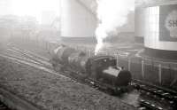 View over the remains of Ardrossan North station on 29 December 1962 with the Shell refinery in the background. (During WWII aviation fuel for the RAF was produced here.) Fireless 0-4-0 steam locomotive no 8 [AB1952/1928] is at work shunting bitumen tanks. The refinery closed in 1986 [see image 23867].<br><br>[R Sillitto/A Renfrew Collection (Courtesy Bruce McCartney) 29/12/1962]