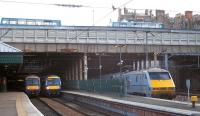 The west end of Edinburgh Waverley on 15 February 2012, with ScotRail Glasgow shuttles headed by Turbostars 170457 and 170426 alongside the 12.00 East Coast service to London King's Cross.<br><br>[Andrew Wilson 15/02/2012]