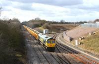 Freightliner 66619 eastbound from Swindon on the afternoon of 16 February 2012 with Network Rail ballast empties. The train is passing the little used access line into the Keypoint rail freight terminal.<br><br>[Peter Todd 16/02/2012]