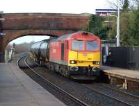 A pleasant change from the more mundane looking Class 66s that normally handle the Lindsey Oil Terminal to Preston Docks tar tank trains. No 60011, in DBS red livery, hauls the returning empty tanks through Lostock Hall on 15 February 2012.<br><br>[John McIntyre 15/02/2012]