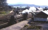 A Black 5 with a Stranraer-bound train pauses at Newton Stewart in April 1965, approximately 2 months before closure. The station was formerly the junction for the Whithorn branch, which had closed completely the previous year. Latterly, Newton Stewart was served by just four trains a day in each direction, including 'The Northern Irishman' sleeper/boat train operating between London Euston and Stranraer Harbour.<br><br>[Frank Spaven Collection (Courtesy David Spaven) /04/1965]