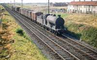 Scene on the western edge of Edinburgh in the summer of 1959. St Margarets J37 0-6-0 no 64543 is passing new housing developments at Broomhall southbound on the Forth Bridge line with a freight heading towards Saughton Junction.<br><br>[A Snapper (Courtesy Bruce McCartney) 25/07/1959]