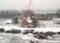 Work progressing on Nuneaton's North chord on 4 February 2012, with the WCML running across the centre background. The concrete bridge under construction here will span a farm road.<br><br>[Ken Strachan 04/02/2012]