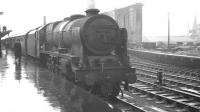 Another wet summer Saturday at Carlisle on 17 August 1963 with Royal Scot no 46128 <I>'The Lovat Scouts'</I> at platform 1 ready to take forward the 10.35 ex-Blackpool, conveying through coaches for Perth and Edinburgh Princes Street.<br><br>[K A Gray 17/08/1963]