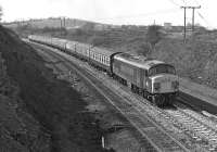 A northbound express, possibly the 08.00 St Pancras - Glasgow, approaching Normanton from the Cudworth direction in April 1976 with 45 057 in charge, still sporting the split headcode panels fitted to earlier members of the class. The chimney and cooling towers visible above the loco belonged to Wakefield power station in whose shadow stood Wakefield shed [see image 21784], still in use at the time as a wagon repair shop.<br><br>[Bill Jamieson 03/04/1976]