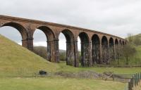 Curving Lowgill viaduct is a landmark for WCML and M6 travellers at the south end of the Lune Gorge. Situated at the north end of the line to Ingleton and Clapham it lost its regular passenger services in 1954 but carried freight, diversions and other occasional trains for a further twelve years before complete closure.<br><br>[Mark Bartlett 25/02/2012]